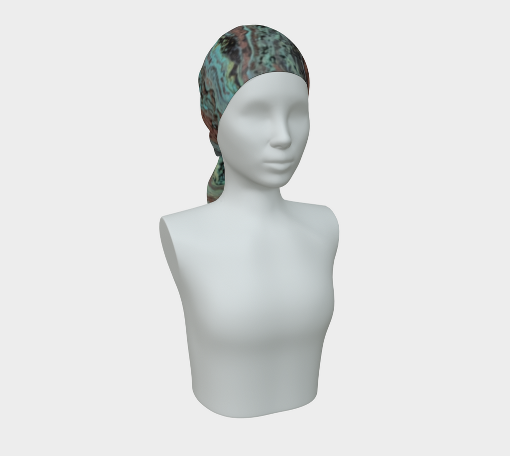 A patterned headscarf with a marbled design in teal, green, brown, and black, styled on a white mannequin bust against a light gray background.