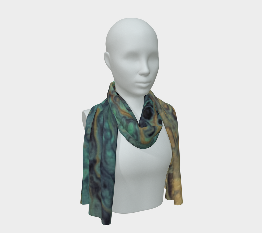 A lightweight scarf with a marbled pattern in teal, green, yellow, and dark gray, draped on a white mannequin torso against a light gray background.